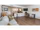 Inviting open-concept living space featuring wood floors, white cabinets, and a comfortable seating area at 4727 E Lafayette Blvd # 211, Phoenix, AZ 85018