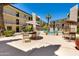 Community pool area surrounded by tables with umbrellas and greenery at 4727 E Lafayette Blvd # 211, Phoenix, AZ 85018