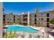 Bright and inviting pool area surrounded by palm trees, lounge chairs, and well-maintained landscaping at 4727 E Lafayette Blvd # 211, Phoenix, AZ 85018
