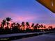Tranquil sunset scenery featuring silhouetted palm trees against a colorful sky near the water at 4727 E Lafayette Blvd # 211, Phoenix, AZ 85018