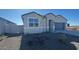 Charming single-story home featuring a modern gray exterior, a two-car garage, and a xeriscaped front yard at 48402 N Duran Way, Gold Canyon, AZ 85118