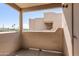 Balcony with concrete floor and walls with a view to the street with palm trees at 5035 N 17Th Ave # 205, Phoenix, AZ 85015