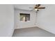 Bedroom with neutral carpet, ceiling fan, and window overlooking the outside common area at 5035 N 17Th Ave # 205, Phoenix, AZ 85015