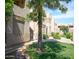 Exterior view of condo units featuring mature trees and a well-maintained lawn at 5035 N 17Th Ave # 205, Phoenix, AZ 85015