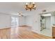 Open-concept living room showcasing wood floors, a patio door and view to kitchen at 5035 N 17Th Ave # 205, Phoenix, AZ 85015
