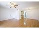 Bright living room with wood floors, ceiling fan and view to the open kitchen at 5035 N 17Th Ave # 205, Phoenix, AZ 85015