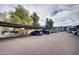 Parking area under awning with multiple parking stalls and view to the common area at 5035 N 17Th Ave # 205, Phoenix, AZ 85015