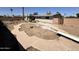 Home's backyard features pool area, block fence, and desert landscaping at 5042 S 22Nd St, Phoenix, AZ 85040