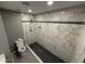 Full bathroom featuring marbled tile shower with built-in niche and rain shower head at 5042 S 22Nd St, Phoenix, AZ 85040