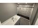 Bathroom features marble tile, a gray vanity and a walk in shower at 5042 S 22Nd St, Phoenix, AZ 85040