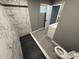 Stylish bathroom features marble tile shower, gray flooring, and modern vanity at 5042 S 22Nd St, Phoenix, AZ 85040