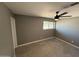 Bedroom features tile flooring, neutral walls and a modern ceiling fan fixture at 5042 S 22Nd St, Phoenix, AZ 85040