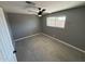 Bedroom features tile flooring, neutral walls and a modern ceiling fan fixture at 5042 S 22Nd St, Phoenix, AZ 85040