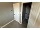 Hallway features tile flooring and neutral walls leading to a storage closet at 5042 S 22Nd St, Phoenix, AZ 85040