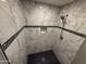 Shower featuring designer marble look tile and dark contrasting stripe at 5042 S 22Nd St, Phoenix, AZ 85040