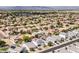 Suburban aerial view, highlighting well-spaced homes, green foliage, and neat landscaping with mountain views at 512 E Bamboo Ln, San Tan Valley, AZ 85140