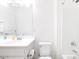 Bright, all-white bathroom with a large mirror, single sink vanity, and shower-tub combo at 512 E Bamboo Ln, San Tan Valley, AZ 85140