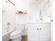 Bathroom featuring a tub, toilet, white sink vanity, and floating wood shelves with decor at 512 E Bamboo Ln, San Tan Valley, AZ 85140