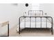 Minimalist bedroom design with black metal bed frame, white walls, and natural light at 512 E Bamboo Ln, San Tan Valley, AZ 85140