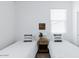 Bright bedroom with two twin beds, white walls, and a center nightstand at 512 E Bamboo Ln, San Tan Valley, AZ 85140
