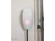 A Tesla EV charger is mounted to the garage wall for convenient electric car charging at 512 E Bamboo Ln, San Tan Valley, AZ 85140