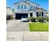 Charming two-story home with a well-kept lawn and a Tesla in the driveway at 512 E Bamboo Ln, San Tan Valley, AZ 85140