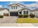 Charming two-story home featuring a dark garage door, well-manicured landscaping, and a welcoming facade at 512 E Bamboo Ln, San Tan Valley, AZ 85140