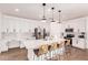 Bright kitchen features white cabinetry, stainless steel appliances, and a center island with seating at 512 E Bamboo Ln, San Tan Valley, AZ 85140