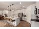 Spacious kitchen featuring an island with seating, stainless steel appliances, and sleek white cabinets at 512 E Bamboo Ln, San Tan Valley, AZ 85140