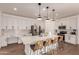 Modern kitchen with white cabinets, stainless steel appliances, a large island, and barstool seating at 512 E Bamboo Ln, San Tan Valley, AZ 85140