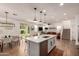 Modern, open-concept kitchen with a large island, stainless steel appliances, and sleek white cabinetry at 512 E Bamboo Ln, San Tan Valley, AZ 85140