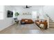Bright living room with modern furniture, a ceiling fan, and a view of the staircase at 512 E Bamboo Ln, San Tan Valley, AZ 85140