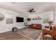 Comfortable living room with a brown leather sofa, a plush rug, and a minimalist design at 512 E Bamboo Ln, San Tan Valley, AZ 85140