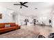 Open-concept living area with a modern kitchen, dining space, and cozy seating area at 512 E Bamboo Ln, San Tan Valley, AZ 85140