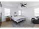 Bright primary bedroom featuring a stylish black metal bed frame, ceiling fan, and neutral decor at 512 E Bamboo Ln, San Tan Valley, AZ 85140
