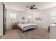 Bright main bedroom with carpet and modern decor, with side barn door at 512 E Bamboo Ln, San Tan Valley, AZ 85140