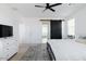 Bright primary bedroom featuring a stylish sliding barn door and a view to the Primary bathroom at 512 E Bamboo Ln, San Tan Valley, AZ 85140
