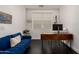 Modern office space with sleek desk, blue sofa and stylish accents at 512 E Bamboo Ln, San Tan Valley, AZ 85140