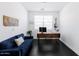 Stylish office with a modern wood desk, comfortable blue couch, and sleek black floors for a contemporary workspace at 512 E Bamboo Ln, San Tan Valley, AZ 85140