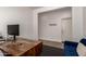 Bright office space with modern desk, monitor, and a comfortable blue sofa at 512 E Bamboo Ln, San Tan Valley, AZ 85140