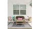 Cozy outdoor patio area with stylish chairs, cushions, rug, and string lights at 512 E Bamboo Ln, San Tan Valley, AZ 85140