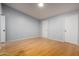 This bedroom has light blue walls and hardwood floors with two doors at 5135 E Evergreen St # 1166, Mesa, AZ 85205