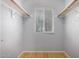 An open closet with shelves, rods, and a window for natural light at 5135 E Evergreen St # 1166, Mesa, AZ 85205