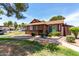 Traditional single-story home with manicured lawn, complemented by mature trees and a paved walkway at 5135 E Evergreen St # 1166, Mesa, AZ 85205