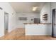 Open living area featuring wood floors, ceiling fan and bar to the kitchen at 5135 E Evergreen St # 1166, Mesa, AZ 85205