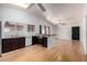 An open concept living room features vaulted ceilings, wood floors and flows into the kitchen at 5135 E Evergreen St # 1166, Mesa, AZ 85205