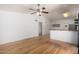 Spacious living area featuring wood floors, ceiling fan and bar to the kitchen at 5135 E Evergreen St # 1166, Mesa, AZ 85205