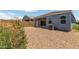Low-maintenance backyard with gravel landscaping, patio, and partial landscaping at 5240 E Gummite Dr, San Tan Valley, AZ 85143