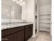 This bathroom offers dual sinks with a granite countertop and a linen closet for storage at 5240 E Gummite Dr, San Tan Valley, AZ 85143