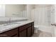 Bathroom featuring a stylish vanity with granite countertop and shower-tub combination at 5240 E Gummite Dr, San Tan Valley, AZ 85143